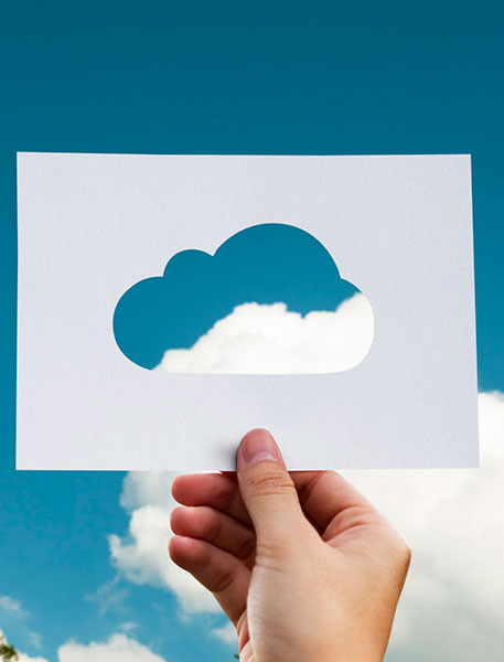 Cloud server load balancing visually represented by paper cloud cutout.